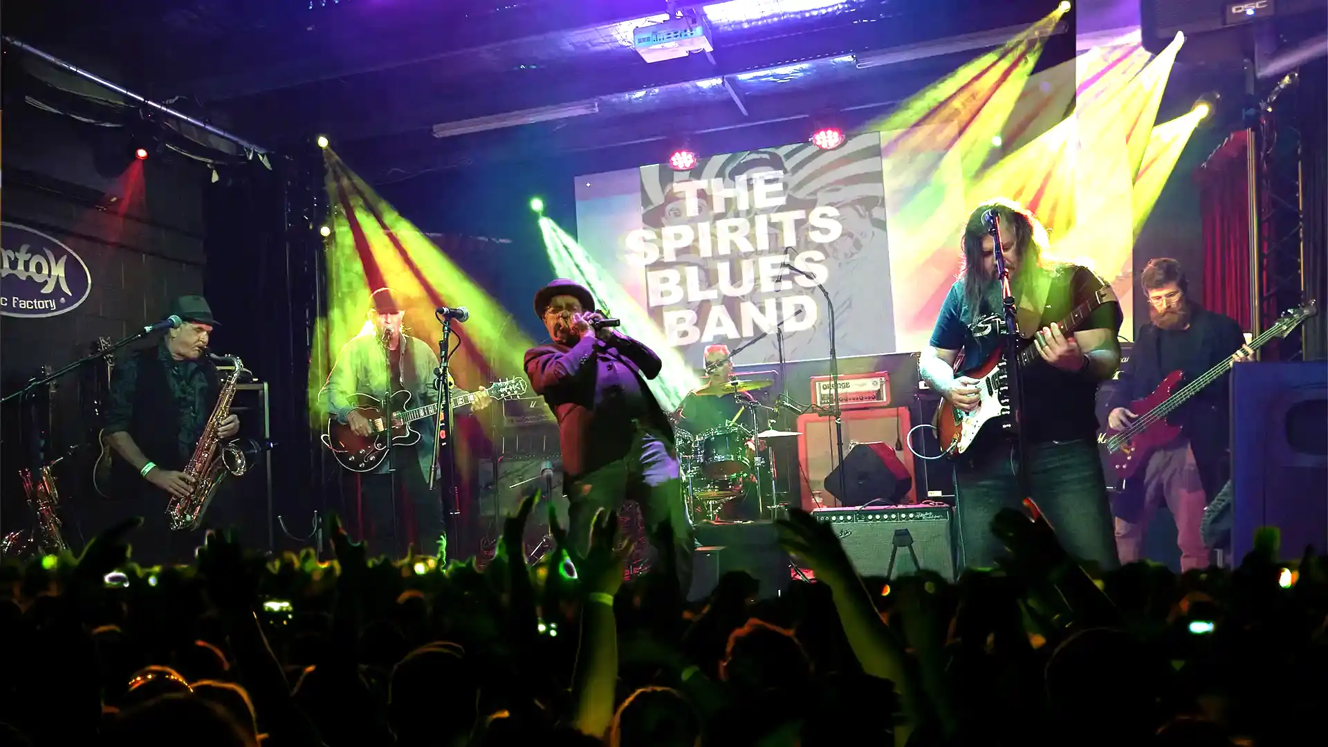 The Spirits onstage with a crowd in front - pumping the blues big time - Roger on sax, Ian on harp and Alex on guitar in full flight - hard core Blues with a great crowd out front